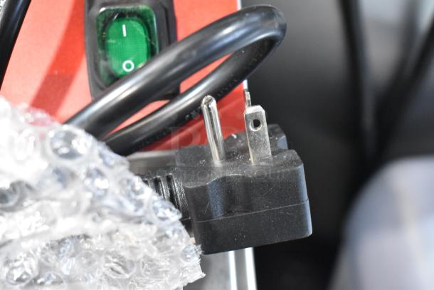 Close-up of power plug and switch of the Avantco 177F200 electric countertop fryer, new with bubble wrap.
