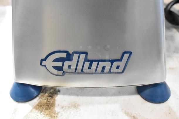 Brand new Edlund metal commercial countertop patty former. Features scratch and dent condition. Visible Edlund logo.