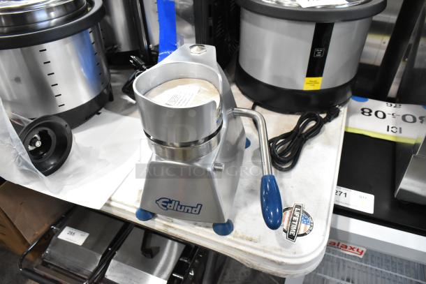 Brand new Edlund metal commercial countertop patty former with minor scratches. Features durable build and manual handle.
