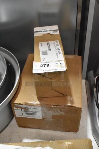 Two boxes of new items: C Pure Oceanloch-S water filtration system and Traulsen Ec Axial fan blade. Labels intact.