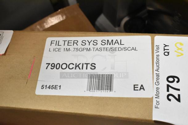 Brown shipping box with label showing "FILTER SYS SMAL," "790OCKITS," and barcode for a water filtration system.