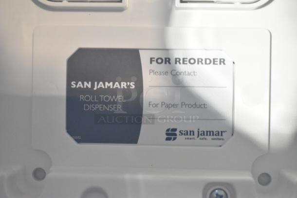 BRAND NEW SCRATCH AND DENT! San Jamar Roll Towel Dispenser, white, includes reorder label, slight blemishes visible.