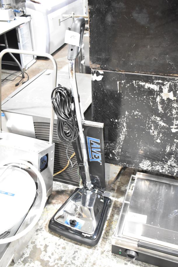 Brand new Lavex P101 commercial vacuum cleaner with scratch and dent, 120 volts, 1 phase. Handle wrapped cord, chrome finish.