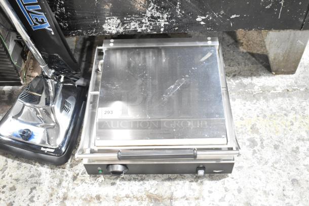 BRAND NEW 2025 Vollrath TSI7021 stainless steel Panini grill, 17"x16" smooth plates, 120V, minor scratches, model tag visible.