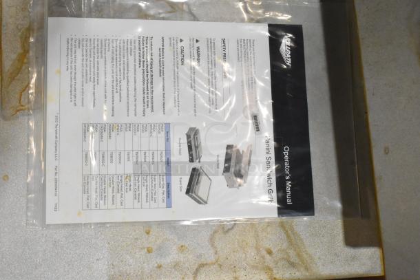 Operator's manual for Vollrath TSI7021 panini grill in a clear plastic bag, detailing models and safety precautions.