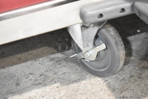 Caster wheel of a 2025 Avantco 177HTESC1836 heated holding cabinet, shown in new condition on a concrete floor.