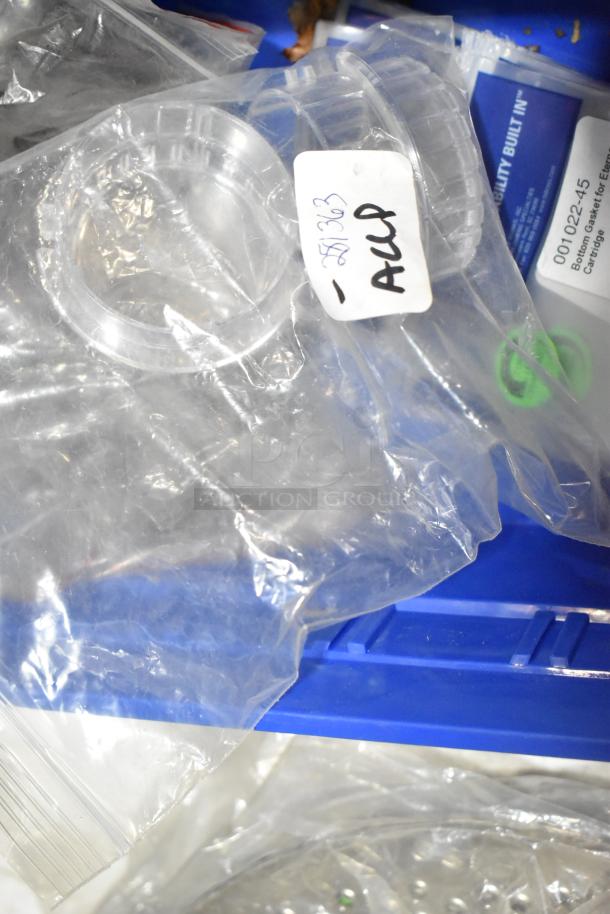 Lot of 21 new items with scratches and dents, includes 001022-45 bottom gasket for Eterna Cartridge; visible tags/labels included.