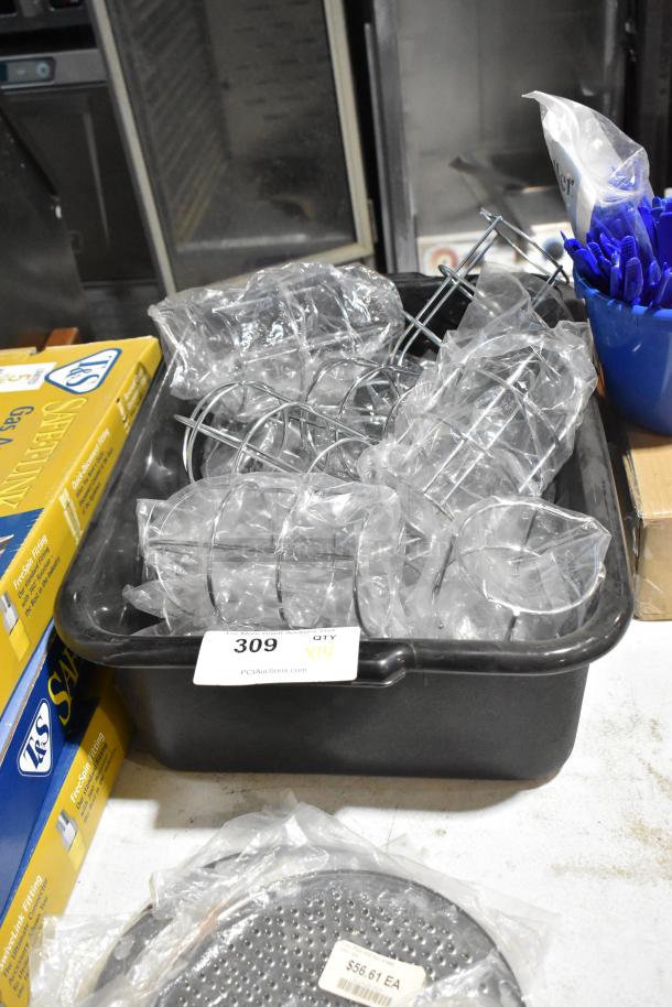 Lot of 14 brand new scratch and dent items, including hood light covers, in black poly bus bin with auction tag.