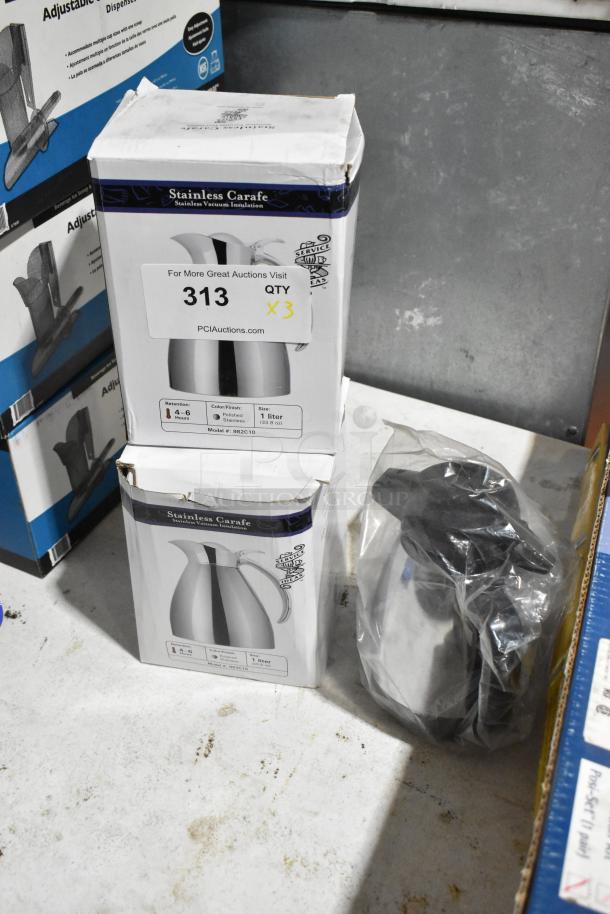 Three brand new stainless steel carafes, each 1 liter, in retail boxes; note: minor box damage, inner items intact.