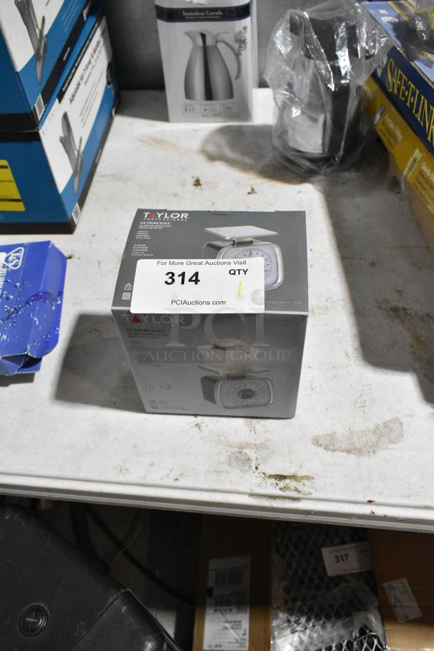 Brand new Taylor Ice Cream Scale in original packaging, slight scratches, visible label “314 QTY” for auction tracking.