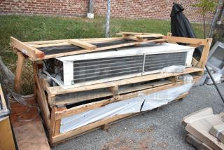 Brand new evaporators in wooden crates, showcasing metal coils and parts. Ready for installation, excellent condition.