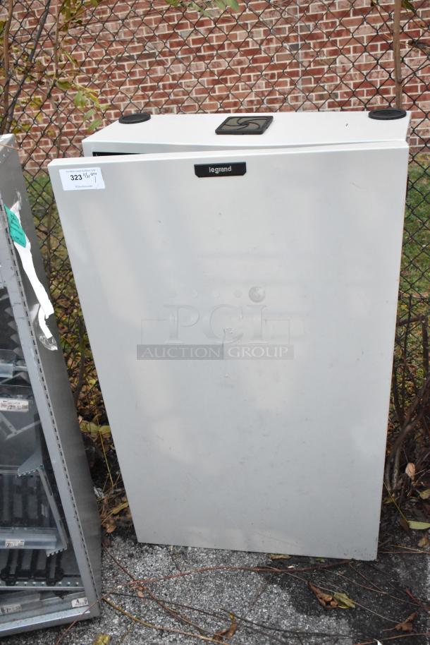 Legrand gray metal cabinet, used condition, rectangular shape. Features Legrand label and top handle. Exterior paint shows wear.