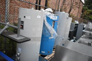 Four tanks including three Bradford White units and a Glacier Opti-stor Heat Recovery System, shown in industrial setting.