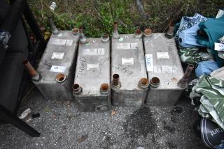 Four Swep 0111282.0 metal units on pavement, showing pipes and labels. Used condition with visible markings and signs of wear.