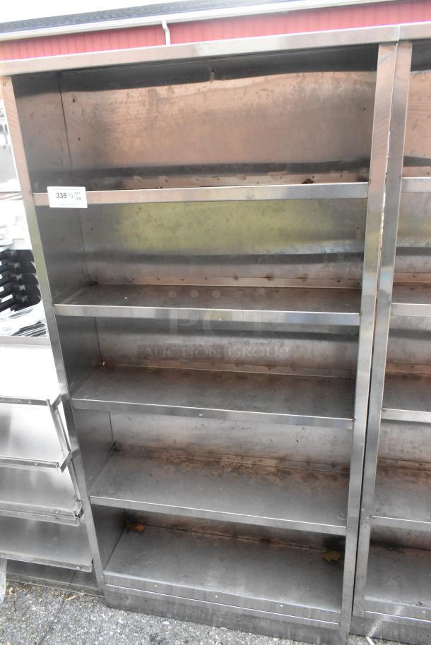 Stainless steel shelving unit with multiple shelves, used condition, numbered label "338," auction item, bid doubles quantity.