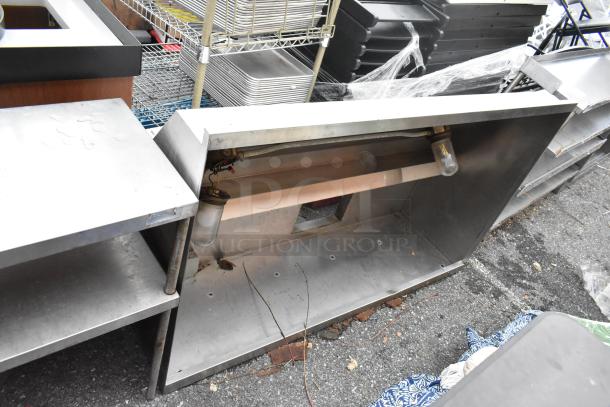5' stainless steel grease hood, used, visible wear and discoloration, includes light fixtures, suitable for commercial kitchen.