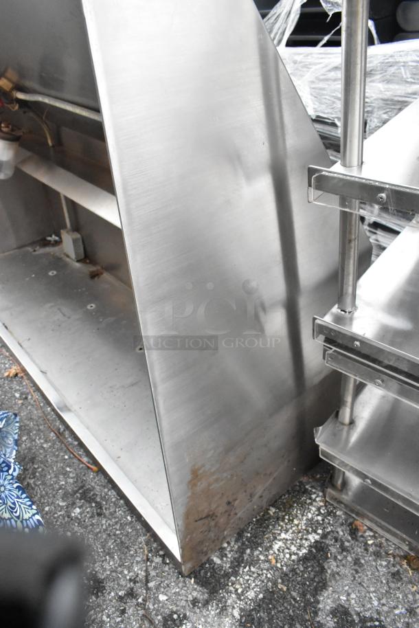 5' stainless steel grease hood, used condition. Visible wear at base, sturdy structure, ideal for commercial kitchens.