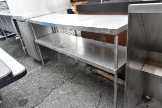 Stainless steel 2-tier over shelf in used condition, featuring durable construction and spacious storage space.