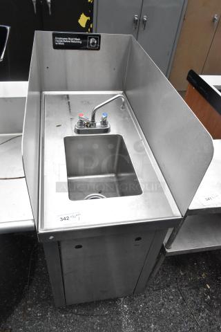 Stainless steel single bay sink with side splash guards, faucet, and handles; good condition with visible label on hygiene.