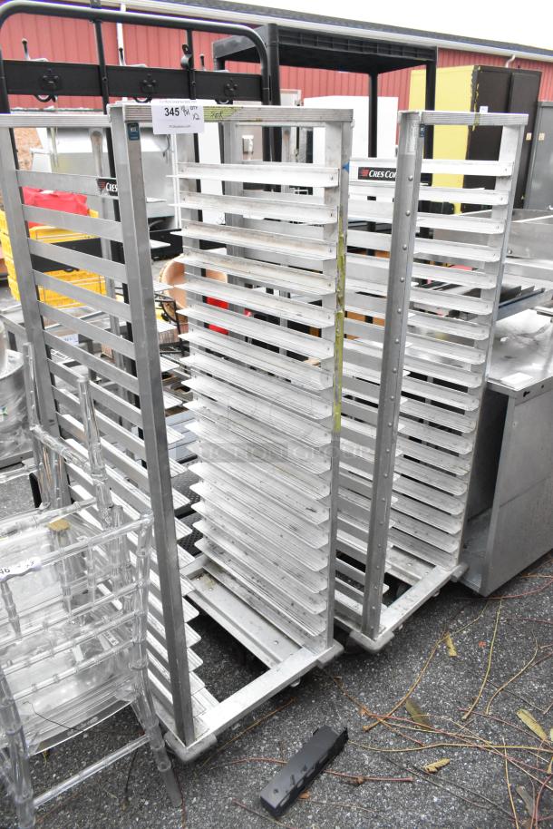 Two metal commercial pan transport racks on casters, holding multiple shelves; ideal for bakery or food service operations.