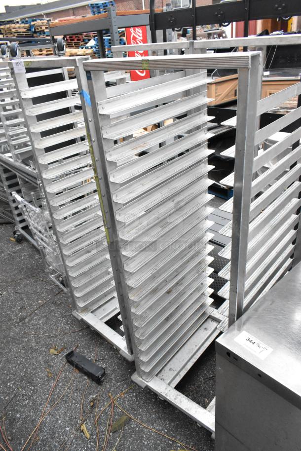 2 metal commercial pan transport racks on casters, good condition, 20 slots each, durable metal construction.