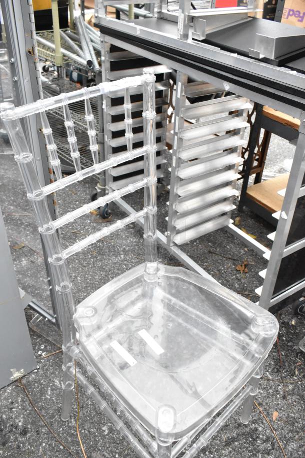 Clear poly stackable Chiavari chair, transparent design, good condition, suitable for events or banquets, auction set of 3.