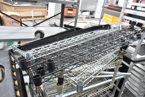 Two wire shelving units with assorted wire shelves and black supports, good condition, stacked on a dolly.