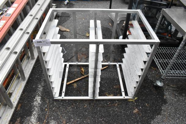 Metal double pan rack with slotted sides, open top, sturdy frame. Shows minimal wear, ideal for kitchen storage.