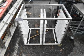 Metal double pan rack with slotted sides, open top, sturdy frame. Shows minimal wear, ideal for kitchen storage.