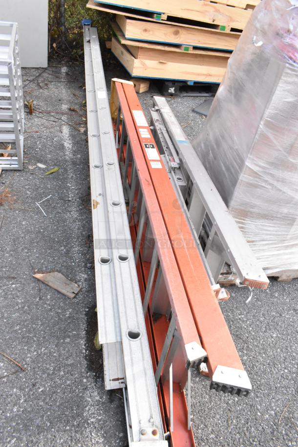 Three aluminum and fiberglass ladders in used condition, featuring safety labels and anti-slip feet. Auction item with potential value.