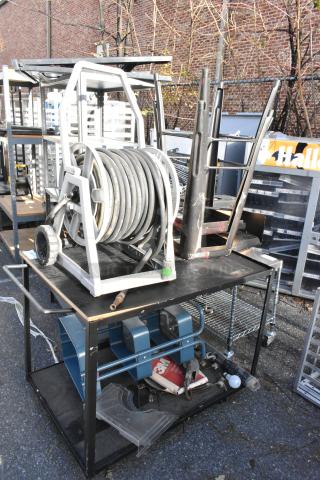 Cart with hose on reel, bar stools, and miscellaneous contents. Visible wear, ideal for garage or workshop use.