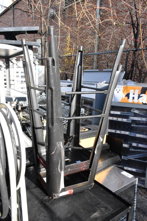 Cart with mounted hose reel and stacked black bar stools. Visible wear. Includes Craftsman-branded hose.
