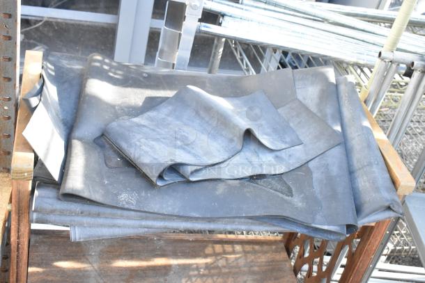 Gray metal shelving unit and wooden 2-tier cart with casters. Includes folded rubber material. Good condition.