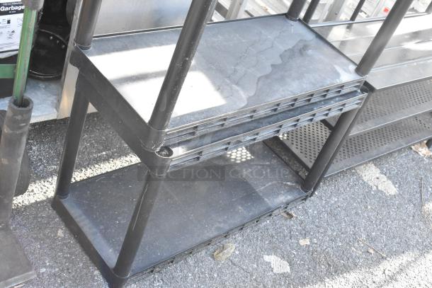 Black 5-tier poly shelving unit, sturdy plastic construction, good condition, ideal for garage or storage use.