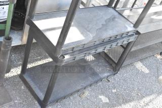 Black 5-tier poly shelving unit, sturdy plastic construction, good condition, ideal for garage or storage use.