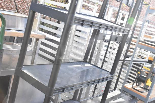 Black 5 tier poly shelving unit, sturdy construction, open design, suitable for storage and organization, good condition.