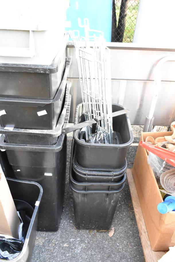 Black poly trash cans in various sizes, stacked outdoors, showing light wear. Sale includes 16 pieces.