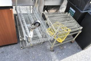 Wire shelving unit and wire dunnage rack on wheels, showing slight wear, with auction tag "386". Suitable for storage.