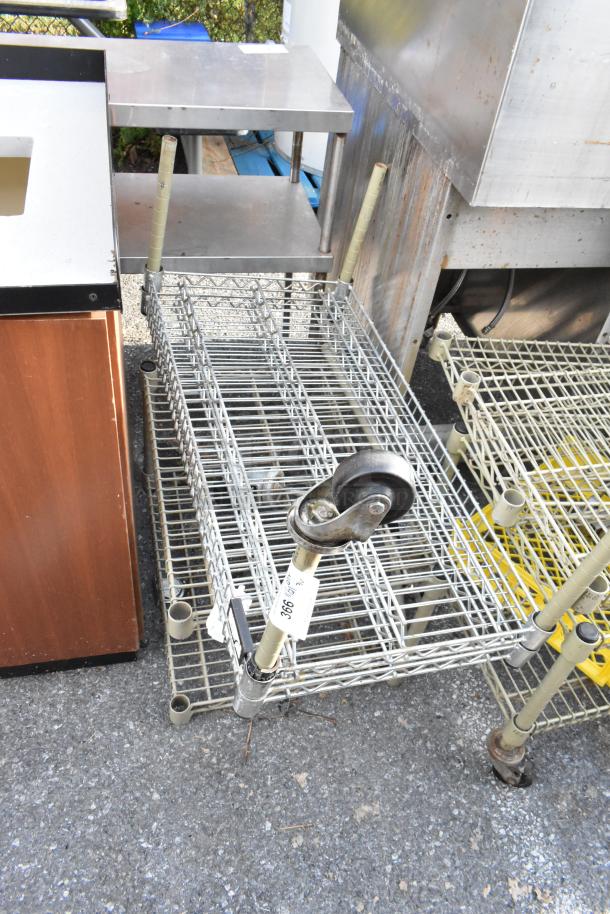 Three items including a wire shelving unit and wire dunnage rack, featuring durable metal construction and a caster wheel, tagged with lot number 366.