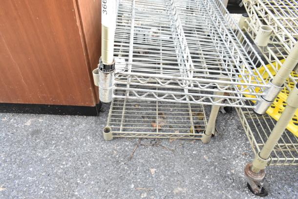 Wire shelving unit and dunnage rack with wheels, metal construction, moderate wear. Includes label marked "366."