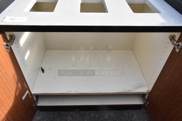 Trash can shell with three deposit holes and two wood pattern doors, showing interior storage space. Visible item label: "367".