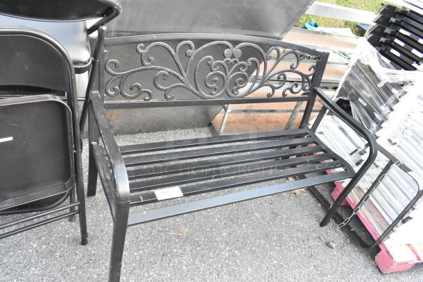 Black metal bench with armrests, ornate backrest design, slatted seat, good condition, item tag labeled "371".