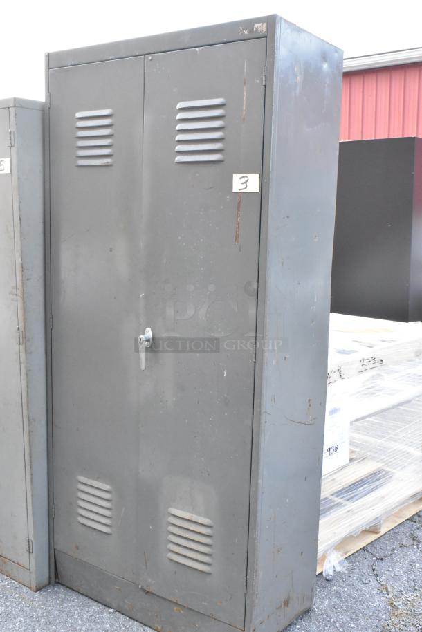 Gray metal cabinet with vented doors, visible wear and rust. Number "3" label on door. Auction offers 2 for winning bid.