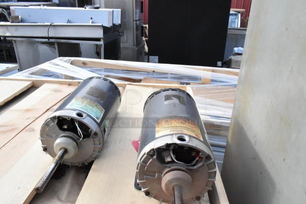 Alt text: Industrial motors on a wooden pallet, surrounded by packaging materials.