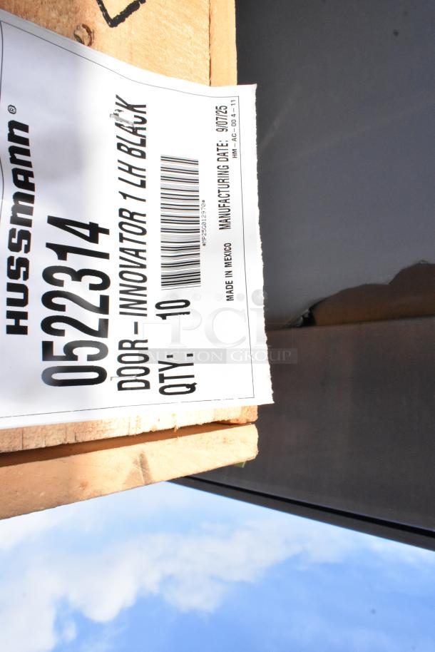 Brand new Hussmann 0522314 Innovator black doors in crate. Label shows "DOOR - INNOVATOR 1 LH BLACK" with quantity 10.