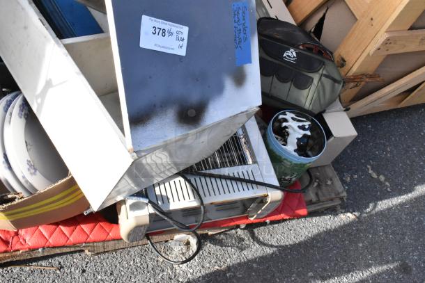 Pallet containing various items including floral dishes, metal bins, and an insulated cooler bag. Auction tag reads "378 qty pallet lot."