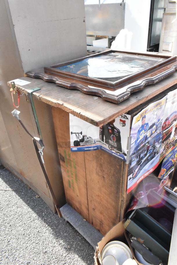 Auction image showing a rustic wooden table with a natural finish. Visible wear on the surface adds character.