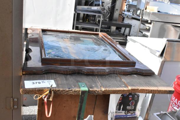 Auction image of a rustic wooden table with visible grain and a sturdy frame. Condition shows natural wear. Tag reads "379."