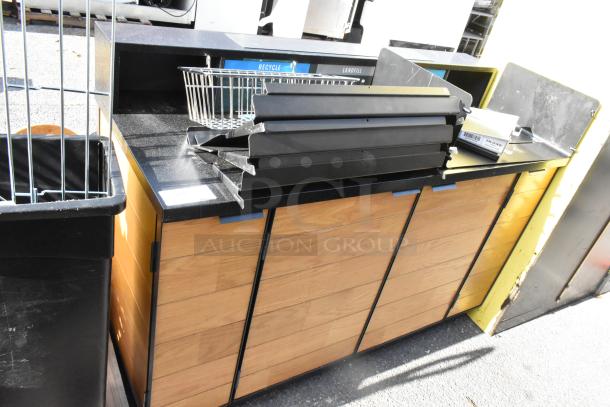 Wooden counter with four doors, black granite top, metal basket, and divider panels. Includes additional contents.
