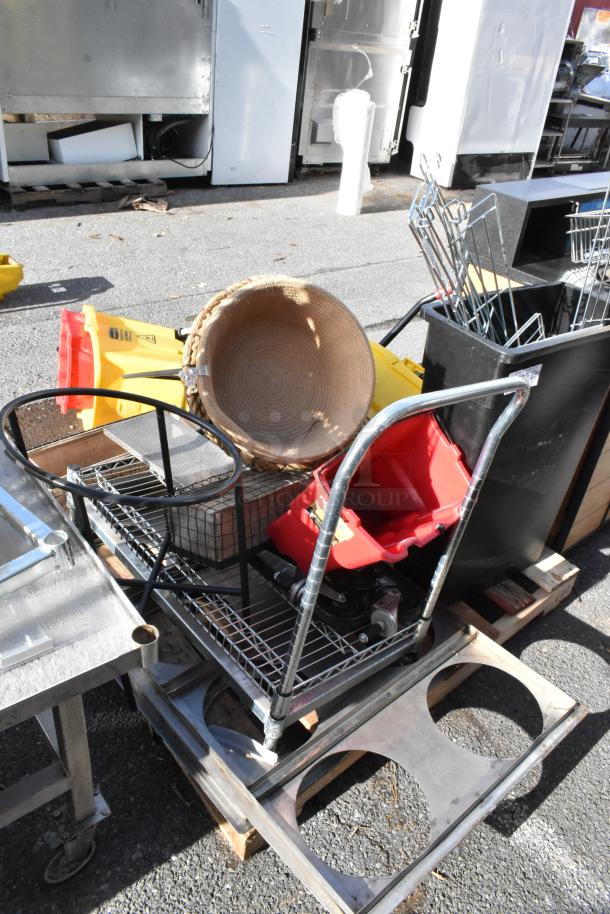 Pallet lot with trash cans, a wheeled cart, red bucket, metal rack, and wicker basket. Assorted items, mixed condition.